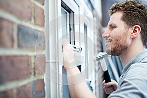 Construction Worker Installing New Windows In House