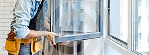 Construction Worker Installing New Windows In House