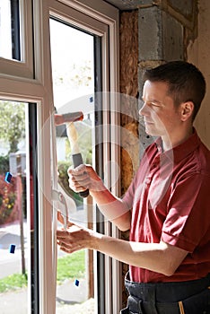 Construction Worker Installing New Windows In House