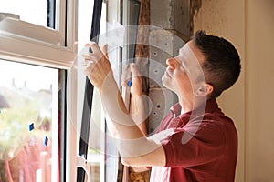 Construction Worker Installing New Windows In House photo