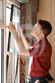 Construction Worker Installing New Windows In House