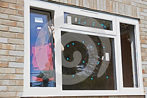 Construction Worker Installing New Windows In House photo