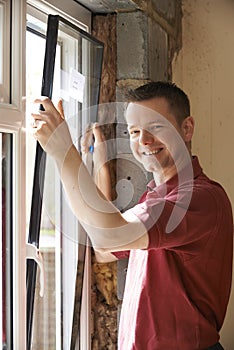 Construction Worker Installing New Windows In House