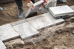 Construction worker installing the pavestone