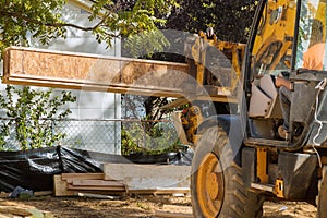 A construction worker installing silent floor joists in new construction forklift stacker loader