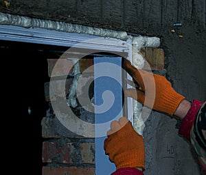 Construction worker installing window in house