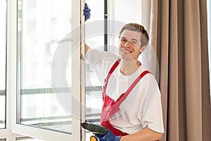 Construction worker installing window in house