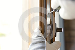 Construction worker installing window in house. Handyman fixing the window with screwdriver