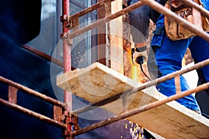 Construction worker insulating house with glass wool, close up