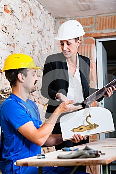 Construction worker and interior designer with door