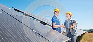 Construction worker and investor in solar power plant shaking hands