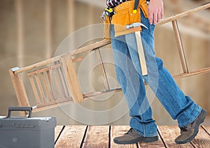 Construction Worker with ladder in front of construction site