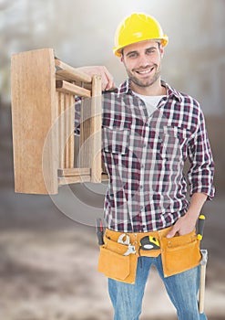 Construction Worker with ladder in front of construction site