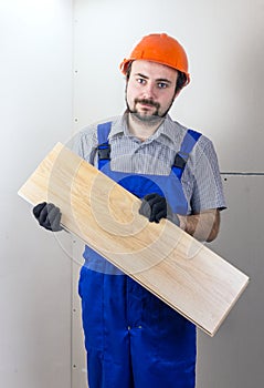 Construction worker with laminated floorboard