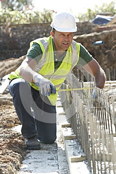 Construction Worker Laying Foundations