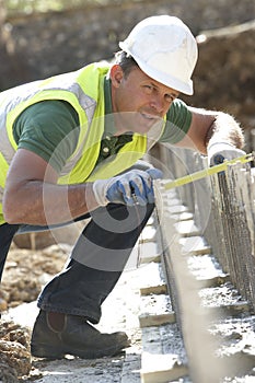 Construction Worker Laying Foundations