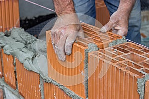 Construction worker laying hollow clay block 2