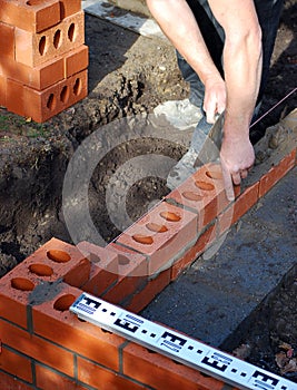 Construction worker lays bricks