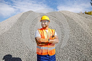 Construction worker is leading production process outdoors