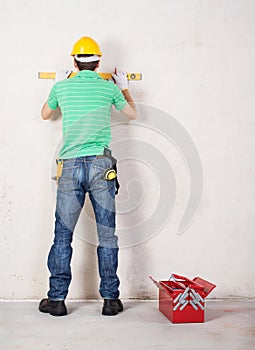 Construction worker with level tool