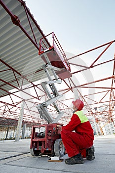 Construction worker with lift equipment photo