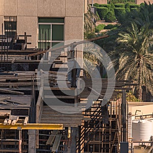 Construction worker lifting heavy load on building site