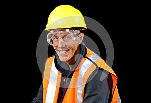 Construction worker male in yellow safety hat, orange vest, red gloves, googles and getting ready to work.