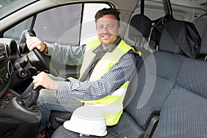 Construction worker man in car van and yellow vest