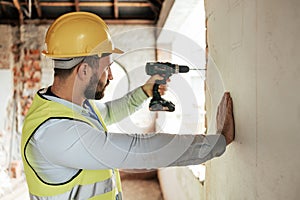 Construction worker, man or drilling wall with electric tool for utility lines, pipes or duct work in office building