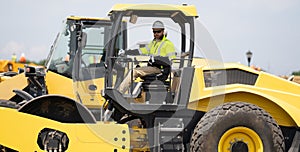 construction worker man drive heavy machinery for road. hispanic man worker at construction machinery outdoor
