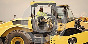 construction worker man drive heavy machinery for road. hispanic man worker at construction machinery outdoor