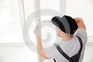 Construction worker man install plastic white upvc windows in house