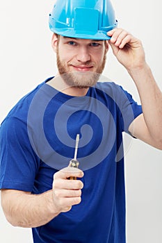 Construction worker man, screwdriver and studio portrait with smile, helmet and ready by white background. Person