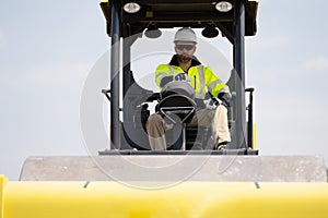 construction worker man use industrial heavy machinery equipment on building industry site for roadwork outdoor