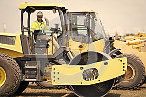 construction worker man used heavy machinery road roller equipment on building industry site for roadwork outdoor