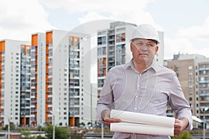 A construction worker man in white helmet holding