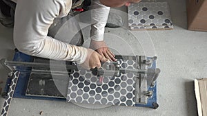 Construction worker man work with floor tile cutting equipment