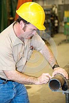 Construction Worker Marking Pipe photo