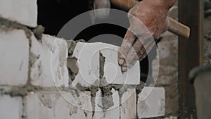 Construction worker or mason laying bricks and creating walls. Bricklayer laying bricks to make a wall. Building a