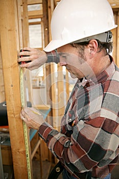 Construction Worker Measuring