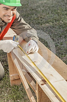 Construction worker measuring a cut