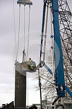 Construction worker operating driller