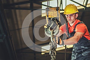 Construction Worker Operating an Overhead Crane at Building Site