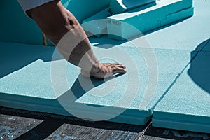 Worker placing XPS polystyrene boards