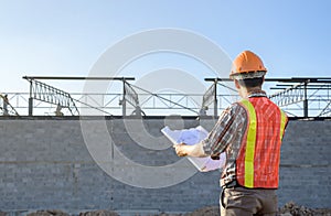 A construction worker plan checking Construction site area During working hours