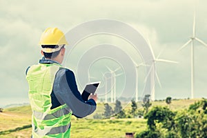 Construction Worker Planning Contractor Checking  at wind turbine construction. A man hold tablet for working