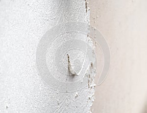 Construction worker plastering and smoothing concrete wall with cement