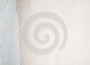 Construction worker plastering and smoothing concrete wall with cement