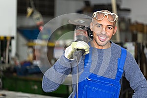 Construction worker posing with angle grinder