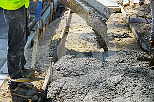 Construction worker pour cement for sidewalk in truck mixer pouring concrete cement for construction sidewalk